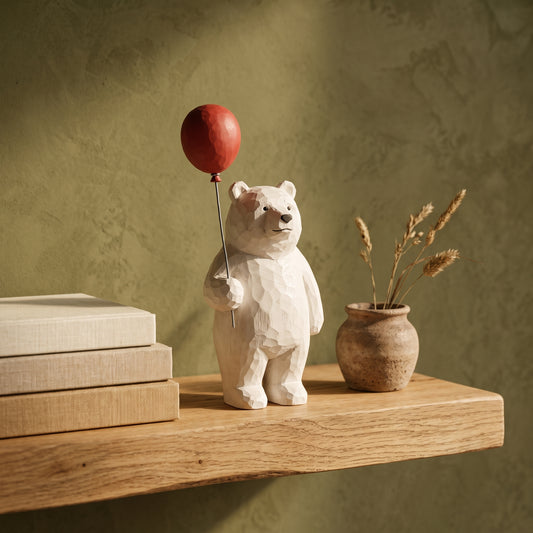 Bruin™ Carved Bear Ornament with red balloon on an oak shelf in Kopflo style