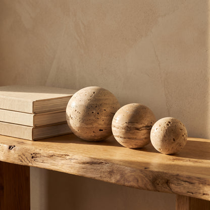 Tivoli™ Stone Spheres lined along an oak console in Kopflo style