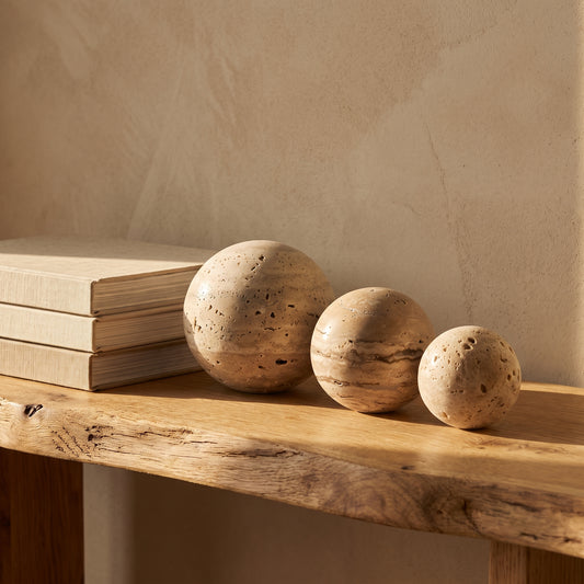 Tivoli™ Stone Spheres lined along an oak console in Kopflo style