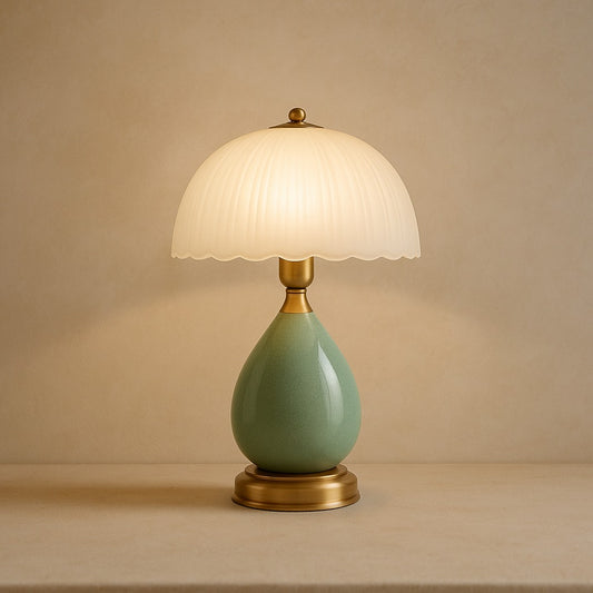 Petal ceramic table lamp with pleated glass shade on warm cream plaster