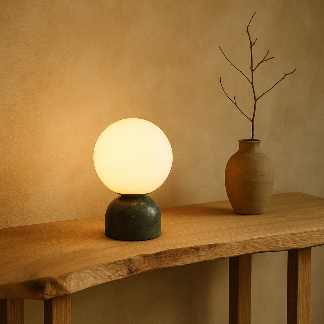 Pearl lamp glowing on a live-edge oak console beside a clay vase