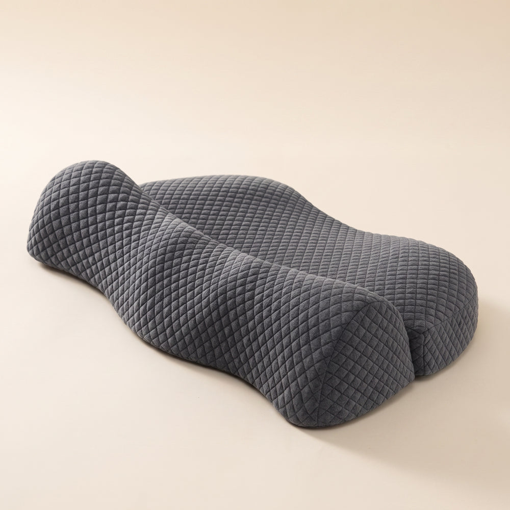 Curve™ Cervical Relief Pillow — charcoal quilted butterfly-contour pillow on warm cream background