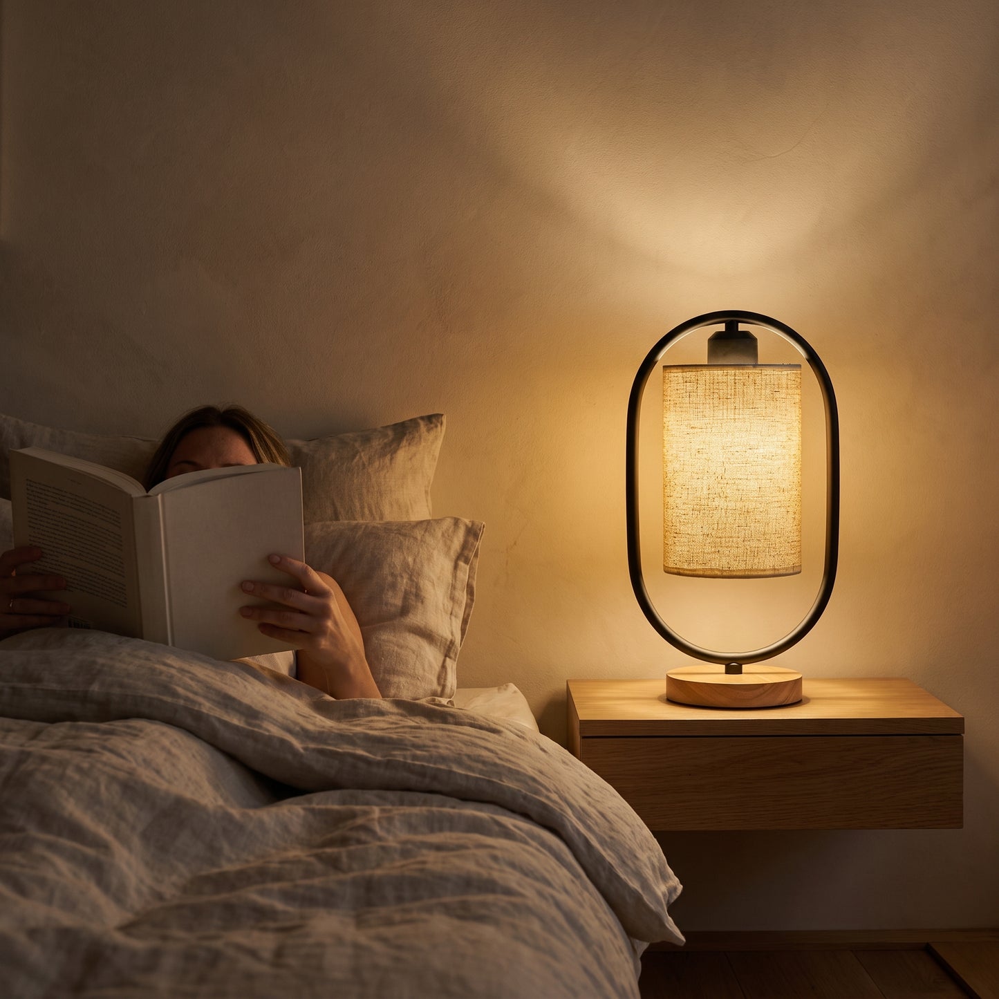 Reading in bed by the black Hoop™ Lantern Table Lamp