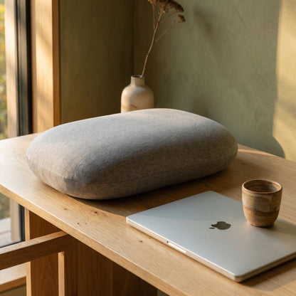 Doze™ Desk Nap Pillow resting on a pale-oak desk in the Kopflo interior