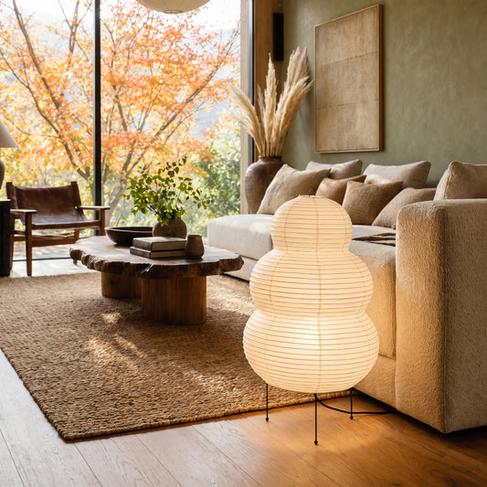 Cocoon™ Paper Table Lamp glowing beside the boucle sofa in the Kopflo living room