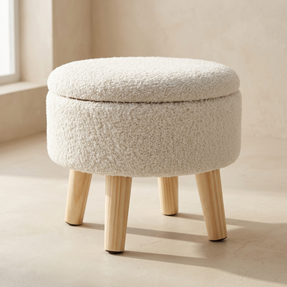 Cache storage ottoman in chalk boucle on four pale wood legs, lid closed