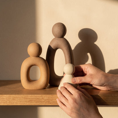 Arranging the Kin™ Family Sculpture Set as evening shadows fall
