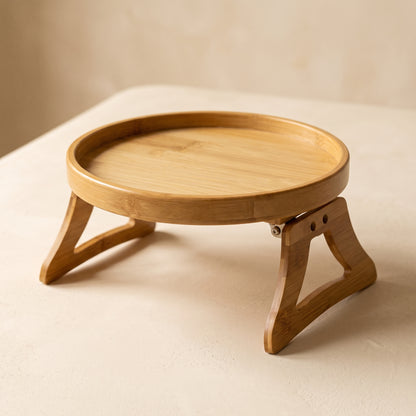 Saddle™ Sofa Arm Tray — round solid bamboo tray with folding clamp legs