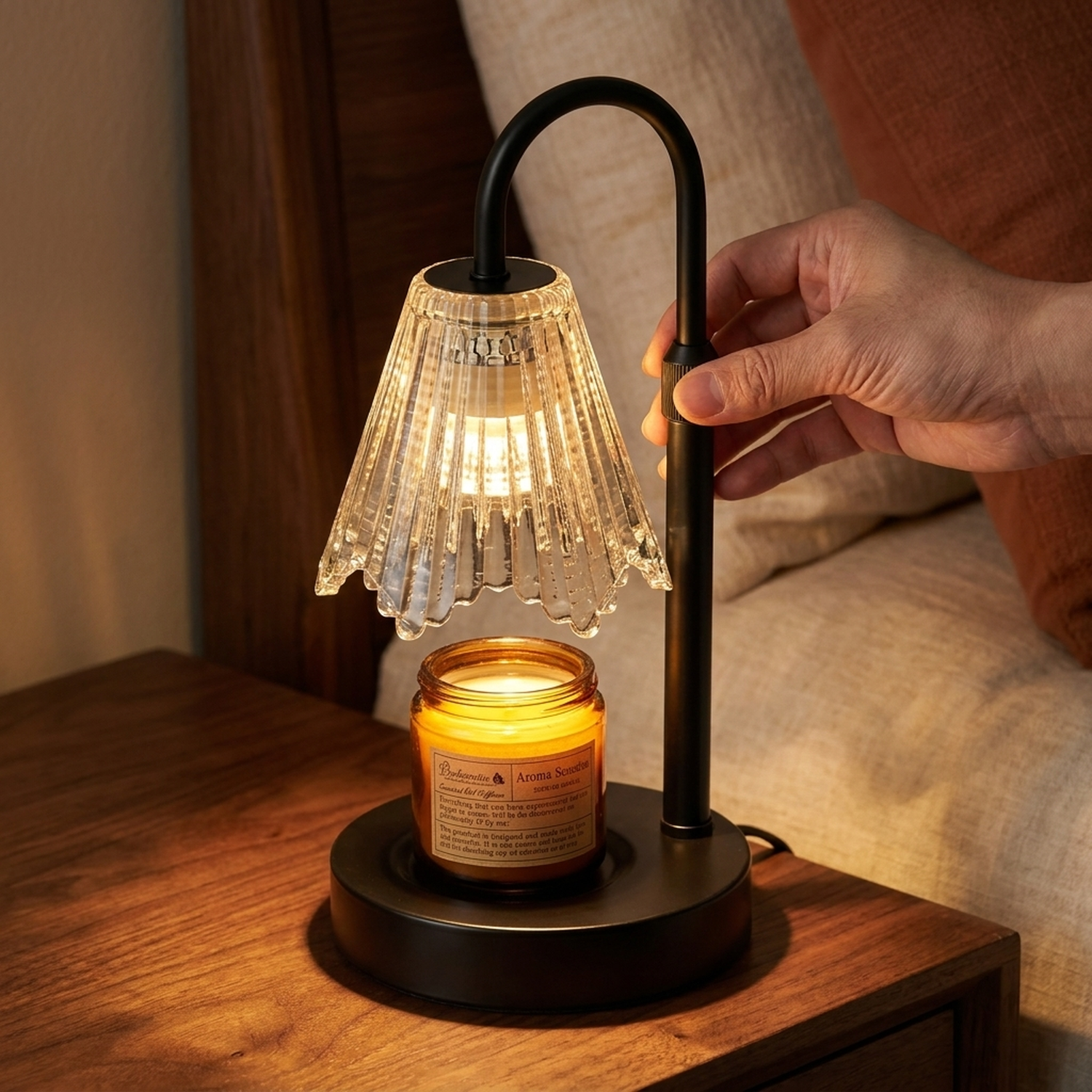Adjusting the telescopic stem of the Taper™ Candle Warmer Lamp on a bedside table