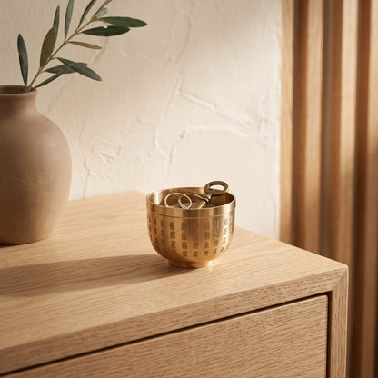 Thimble™ on an oak console holding two rings and a brass key
