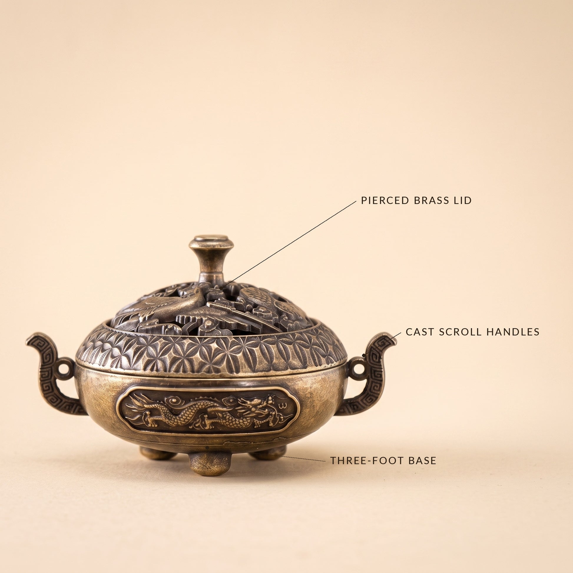 Waft™ Brass Censer detail — pierced brass lid, cast scroll handles, three-foot base