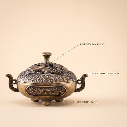 Waft™ Brass Censer detail — pierced brass lid, cast scroll handles, three-foot base