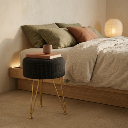 Spool in ink used as a bedside perch beside a low oak bed, holding a book and a cup