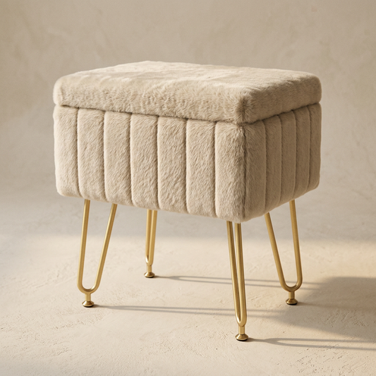 Stow vanity stool in oat faux fur on slim brass legs, closed, on warm cream plaster